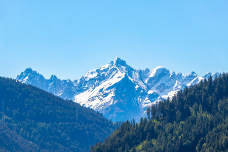 Mountain and alpine hill landscape mountains rocks and peaks panorama with snow green fields forest...