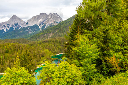 Panoramic view of Germanys largest mountain Zugspitze alpine landscape with turquoise Blindsee lake forest rocks hills and mountains in the Alps Biberwier Reutte Tyrol Austria.の写真素材