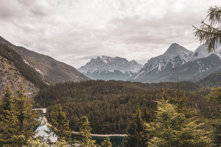 Panoramic view of Germanys largest mountain Zugspitze alpine landscape with turquoise Blindsee lake forest rocks hills and mountains in the Alps Biberwier Reutte Tyrol Austria.の写真素材