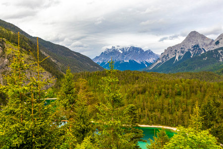 Panoramic view of Germanys largest mountain Zugspitze alpine landscape with turquoise Blindsee lake forest rocks hills and mountains in the Alps Biberwier Reutte Tyrol Austria.の写真素材