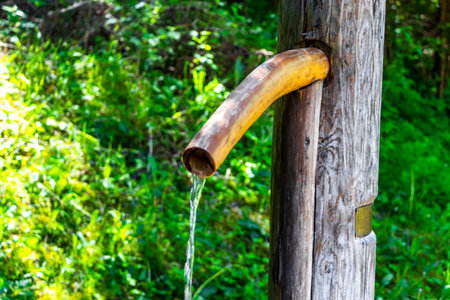 Fliess Landeck Tyrol Austria May 30, 2025 Water dispenser fountain with drinking water in the forest in the Alps Fliess Landeck Tyrol Austria.の写真素材