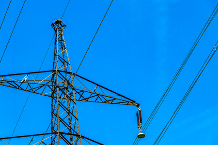 Large electricity pylon power pole with blue sky in the Alps Fliess Landeck Tyrol Austria.