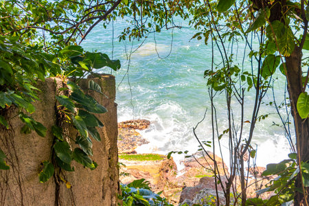 Urca Red Beach Tropical Paradise with Blue Turquoise Water Waves Palm Trees Rocks Hills Cliffs Seascape and White Beach Sand in Rio de Janeiro State of Rio de Janeiro Brazil.の写真素材