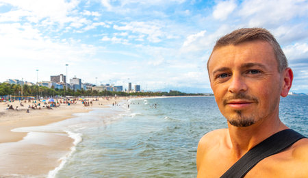 Male Handsome Man Tourist on Flamengo Beach with natural Beach Costa and Seascape Panorama View and...
