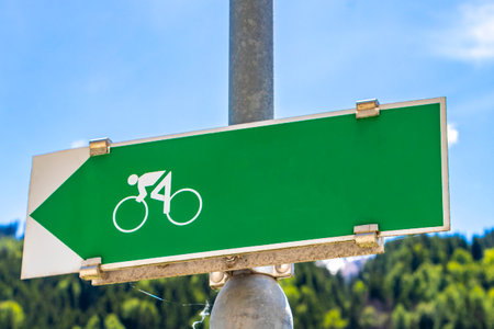 Landeck Tyrol Austria May 30, 2025 Green arrow place and bicycle sign in the direction of in the Alps Fliess Landeck Tyrol Austria.の写真素材
