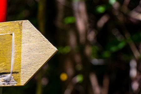 Yellow arrow location and hiking sign direction in the Alps Fliess Landeck Tyrol Austria.