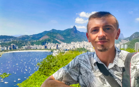 Handsome Man Tourist with the Rio de Janeiro Panorama View of the City Skyline Beaches Beach Coast...