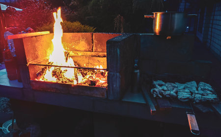 Light the grill and make a fire for a barbecue with chicken.