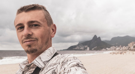 Male tourist takes selfie on Ipanema Beach Tropical Paradise with Blue Turquoise Water Palm Trees...