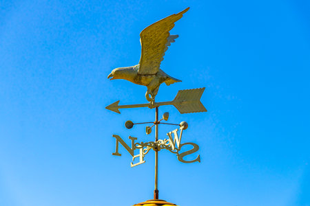 Eagle figure with cardinal directions on the roof ridge.
