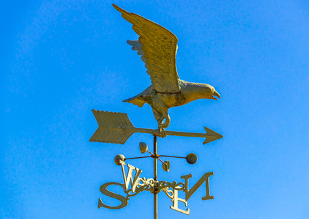 Eagle figure with cardinal directions on the roof ridge in Leninskiy Rayon Brest Brest District...