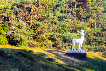 Driving past deer statue sculpture at the forest park and nature in Brest.の写真素材