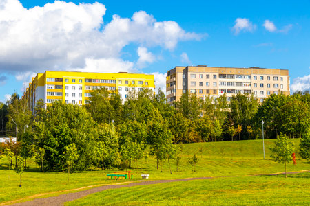 Park with walking path and fields in green nature forest tree trees and blue sky with clouds in Minsk Minsk District Minsk Region Belarus.の写真素材