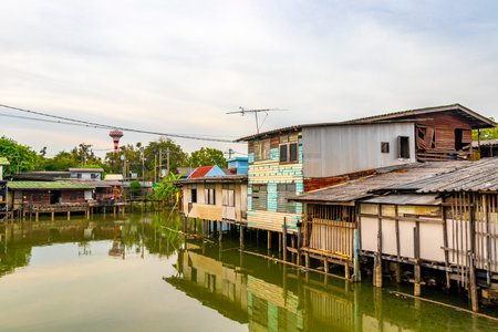 Village town house houses and life along the Prem Prachakon canal and river in Don Mueang Bangkok Central Thailand in Southeastasia Asia.の写真素材