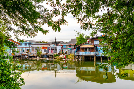 Village town house houses and life along the Prem Prachakon canal and river in Don Mueang Bangkok Central Thailand in Southeastasia Asia.の写真素材