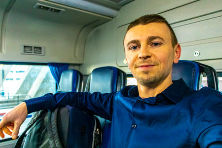 Handsome man tourist with luggage and smile traveling in a bus in Bang Phli District Samut Prakan Province Central Thailand in Southeastasia Asia.の写真素材
