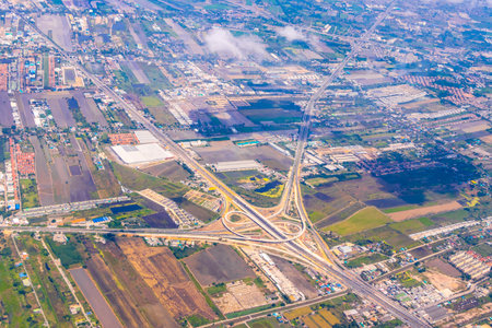 Aerial view of a city town with a panoramic view of the cityscape, skyline, clouds, and blue sky...