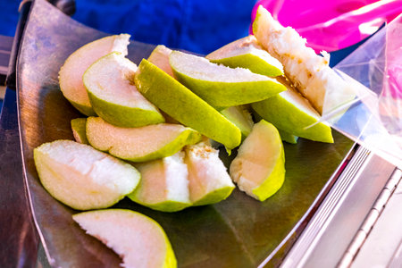Vendor cuts guava fruit into slices in Khon Kaen District Khon Kaen Province Isan Northeast Thailand...