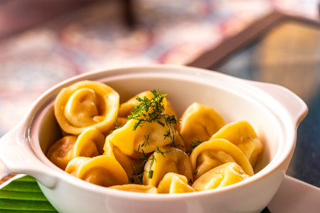 Russian pelmeni in a white plate bowl in a restaurant.の写真素材