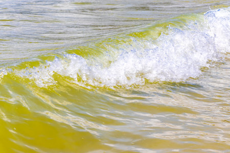 Waves turquoise blue water and sand at tropical beach and sea.の写真素材