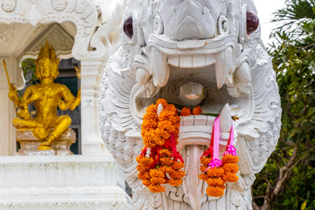 White and golden Thai temple City Pillar Shrine with buddha Naga dragon statue in Patong Beach Thailand.の写真素材
