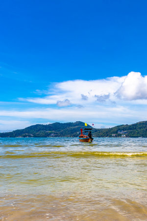 Kathu District Phuket Province Thailand October 13, 2025 Longtail boat long tail boats at the beach with clear blue turquoise water and sky seascape panorama.の写真素材