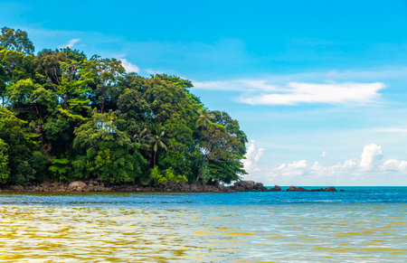 Amazing beach tropical landscape panorama view with turquoise blue water waves and rocks in Patong Beach Kathu District Phuket Island Province Southern Thailand in Southeast Asia.の写真素材