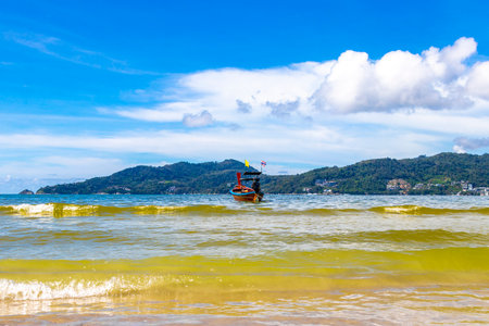 Kathu District Phuket Province Thailand October 13, 2025 Longtail boat long tail boats at the beach with clear blue turquoise water and sky seascape panorama in Patong Beach Phuket Island Thailand.の写真素材