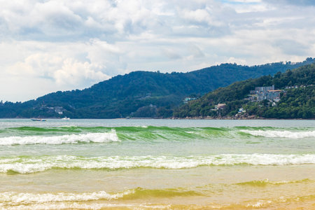 Waves turquoise blue water and sand at tropical beach and sea in Patong Beach Kathu District Phuket Island Province Southern Thailand in Southeast Asia.の写真素材