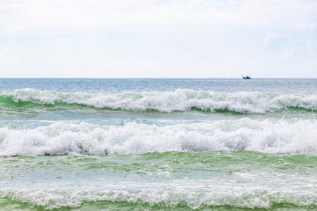 Waves turquoise blue water and sand at tropical beach and sea in Patong Beach Kathu District Phuket...