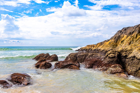 Amazing rocky beach tropical landscape panorama view with turquoise blue water waves and rocks in...