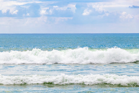 Waves turquoise blue water and sand at tropical beach and sea in Patong Beach Kathu District Phuket...