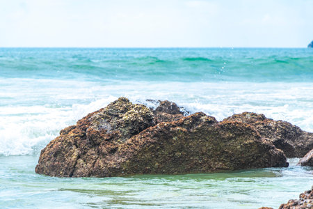 Amazing rocky beach tropical landscape panorama view with turquoise blue water waves and rocks.の写真素材