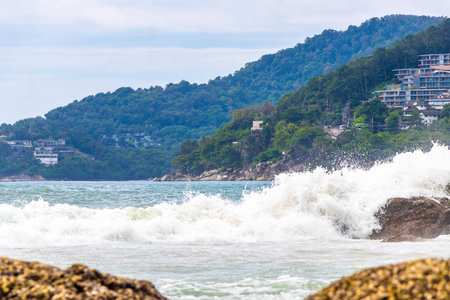 Amazing rocky beach tropical landscape panorama view with turquoise blue water waves and rocks in Patong Beach Kathu District Phuket Island Province Southern Thailand in Southeast Asia.の写真素材