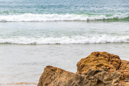 Amazing rocky beach tropical landscape panorama view with turquoise blue water waves and rocks.