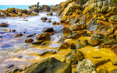 Amazing rocky Kalim Beach tropical landscape panorama view with blue sky turquoise water waves and rocks in Patong Beach Kathu District Phuket Island Province Southern Thailand in Southeast Asia.の写真素材