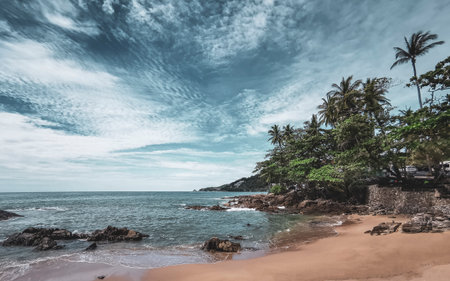 Amazing rocky Kalim Beach tropical landscape panorama view with blue sky turquoise water waves palm...