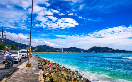 Kathu District Phuket Province Thailand October 26, 2025 Kalim Beach tropical landscape panorama view with blue sky turquoise water waves and rocks at the city town in Patong Beach Phuket Thailand.の写真素材