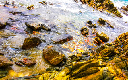 Amazing rocky Kalim Beach tropical landscape panorama view with blue sky turquoise water waves and rocks in Patong Beach Kathu District Phuket Island Province Southern Thailand in Southeast Asia.の写真素材