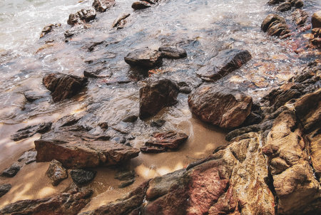 Amazing rocky Kalim Beach tropical landscape panorama view with blue sky turquoise water waves and rocks in Patong Beach Kathu District Phuket Island Province Southern Thailand in Southeast Asia.の写真素材