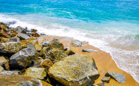 Amazing rocky Kalim Beach tropical landscape panorama view with blue sky turquoise water waves and rocks in Patong Beach Kathu District Phuket Island Province Southern Thailand in Southeast Asia.の写真素材