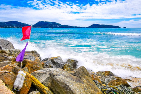 Amazing rocky Kalim Beach tropical landscape panorama view with blue sky turquoise water waves rocks...