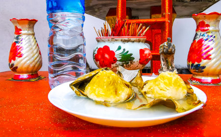 Holy Thai spirit ghost house with offerings of food and drink in Patong Beach Kathu District Phuket Island Province Southern Thailand.の写真素材