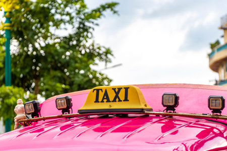 Pink public transportation tuk tuk pick up truck car roofcar cab taxi sign in Patong Beach Kathu District Phuket Island Southern Thailand in Southeast Asia.の写真素材