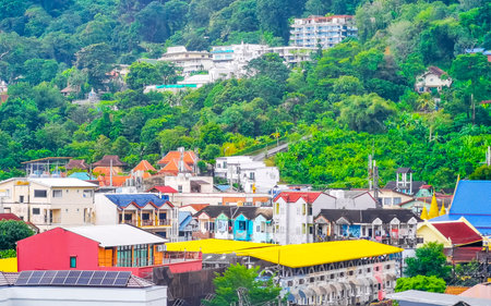 Panoramic view and panorama of tropical landscape mountains city skyline cityscape jungle forest and nature with blue sky in Patong Beach Kathu Phuket Island Province Thailand in Southeast Asia.の写真素材