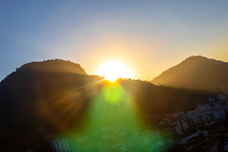 Beautiful golden colorful sunrise sunset behind the tropical mountain mountains hill hills in Angra dos Reis State of Rio de Janeiro.の写真素材