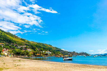 Angra dos Reis State of Rio de Janeiro Brazil October 27, 2020 Panorama of tropical coast beach seascape with turquoise green blue water pier port harbor with boats and palm trees.の写真素材