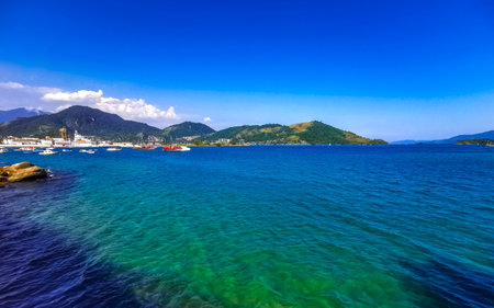 Angra dos Reis State of Rio de Janeiro Brazil October 28, 2020 Panorama of tropical islands island coast beach seascape with turquoise green blue water mountains and pier port with boats in Brazil.の写真素材
