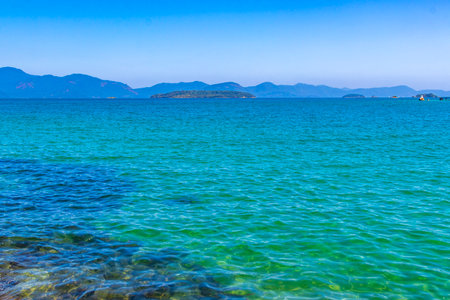 Panorama of tropical islands nature coast beach with turquoise green and clear water rocks boulders and blue sky.の写真素材