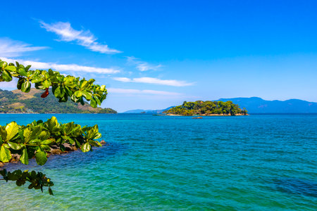 Panorama of tropical islands nature coast beach with turquoise green and clear water rocks boulders and blue sky in Angra dos Reis, Rio de Janeiro, Brazil.の写真素材